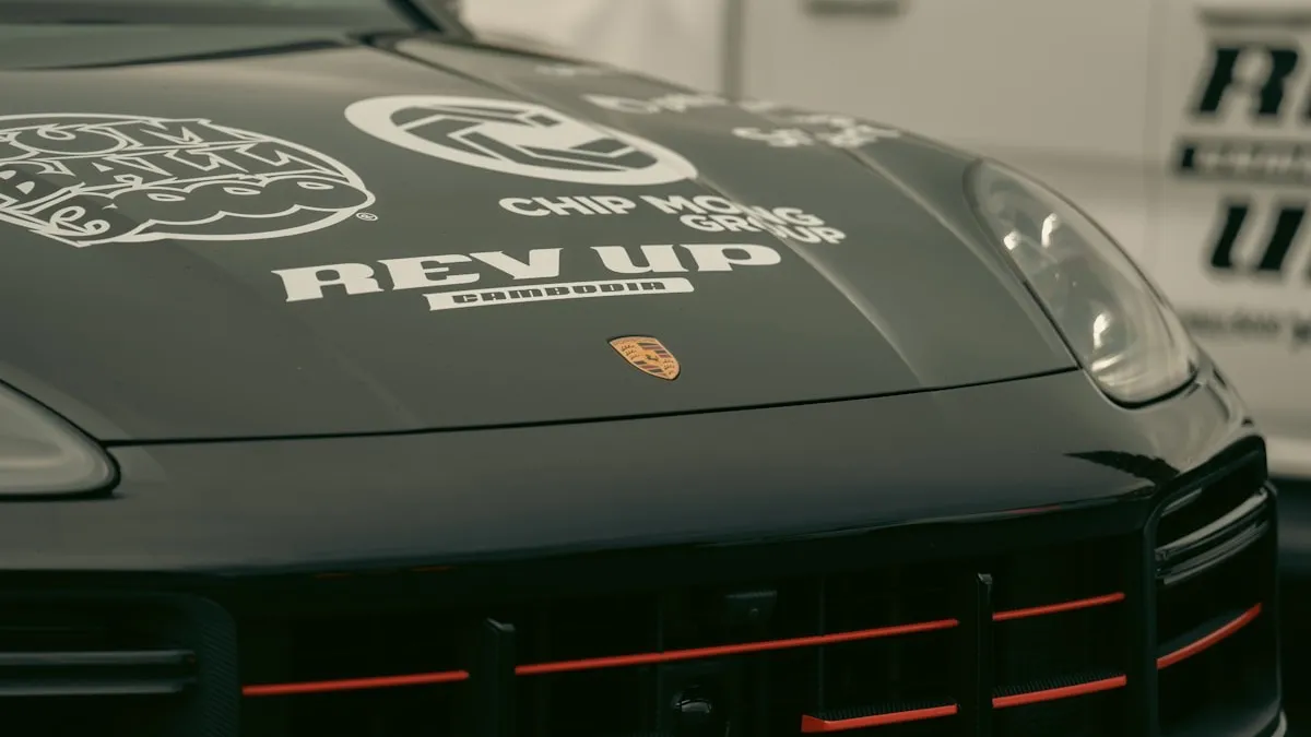 Close-up of ceramic-infused paint protection film showing glossy hydrophobic surface on a vehicle hood