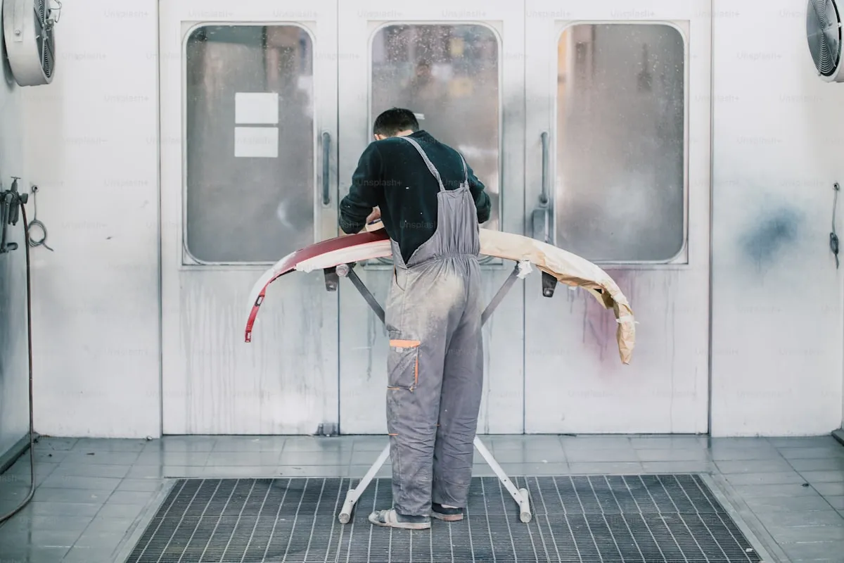 Professional PPF installer working in a controlled clean room environment