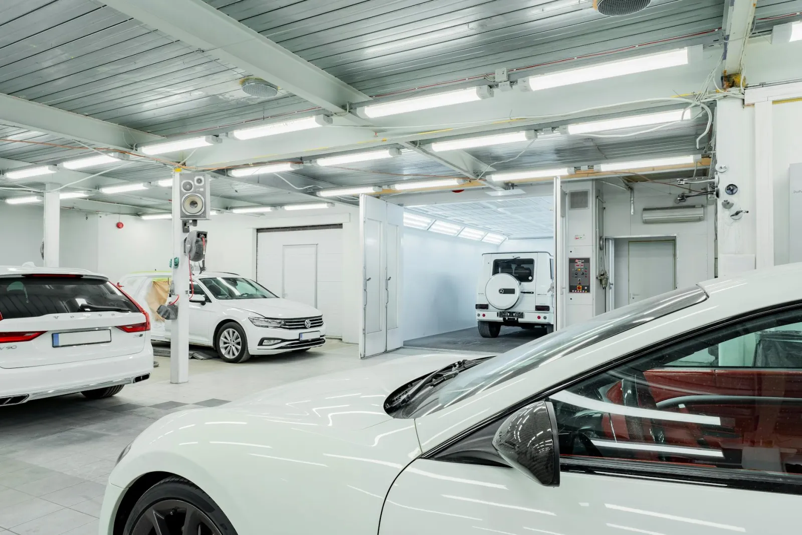 Close-up of a car door panel showing surface swirl marks in direct sunlight