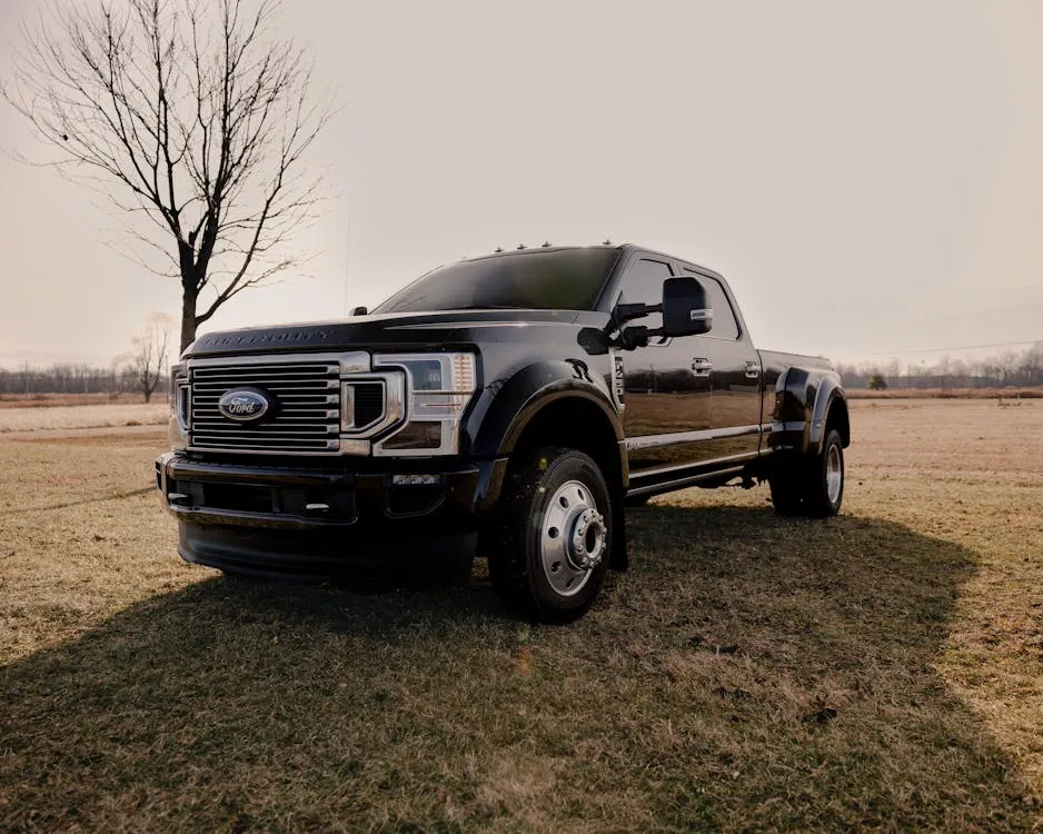 New full-size pickup truck receiving paint protection film at a professional shop