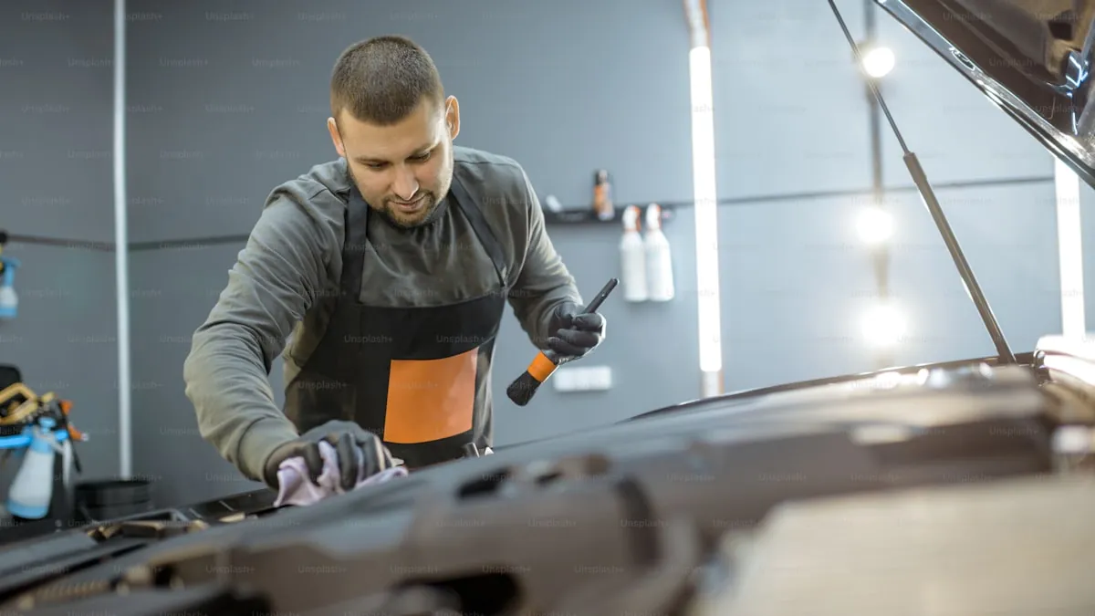 Technician machine polishing a dark-colored vehicle panel in a controlled bay