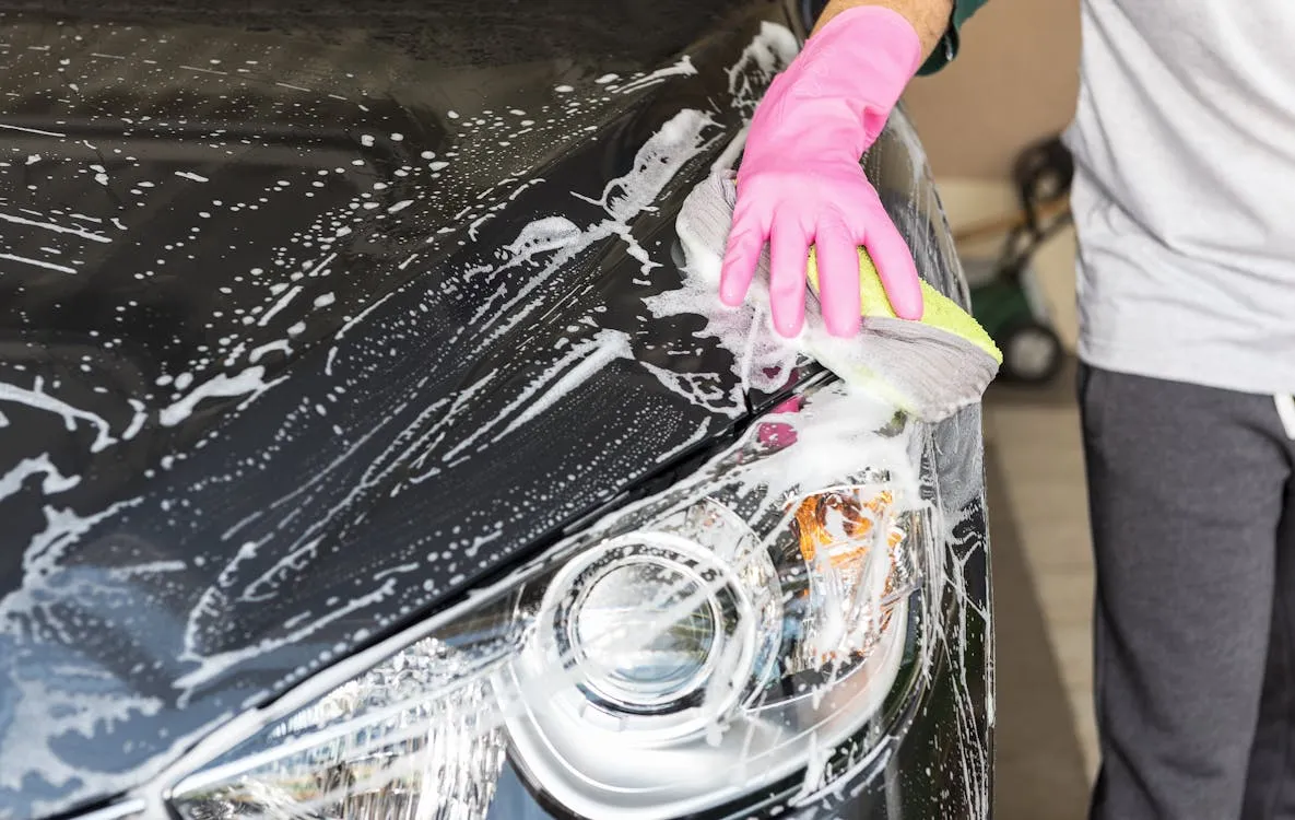 Yellow pollen covering a vehicle's hood and windshield during Texas spring