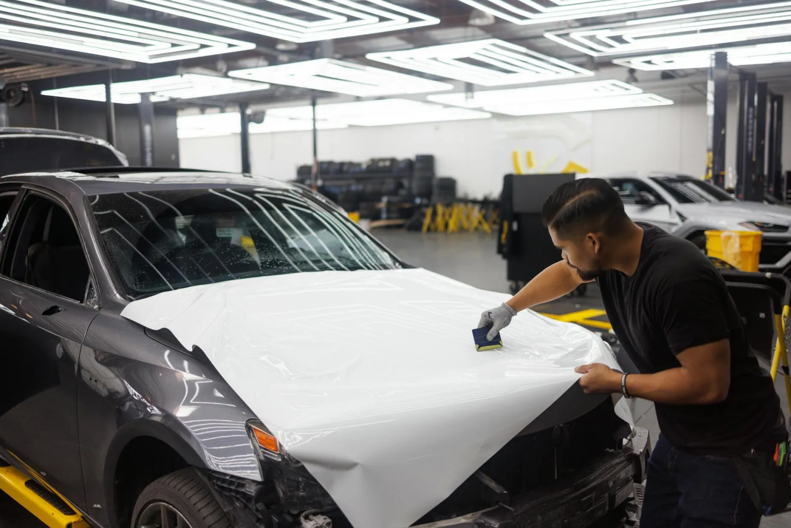 close-up of clear protective film applied to a vehicle hood edge